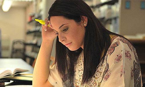 student studying in library